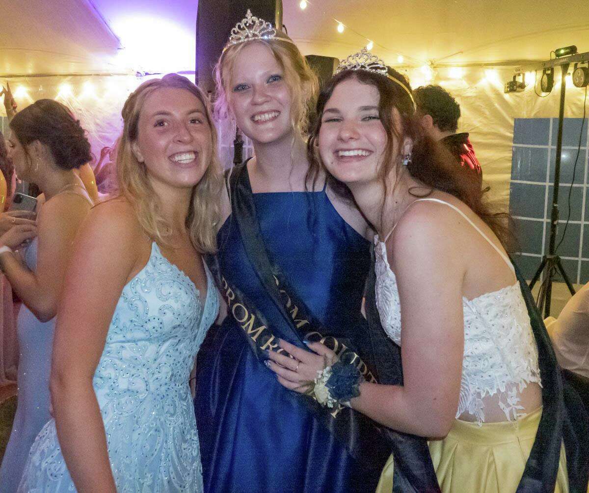 Gabby Biondi, left, congratulates Caitlyn Arnone and Caitlin Daigle on being named the royal couple of the Trumbull High School prom.