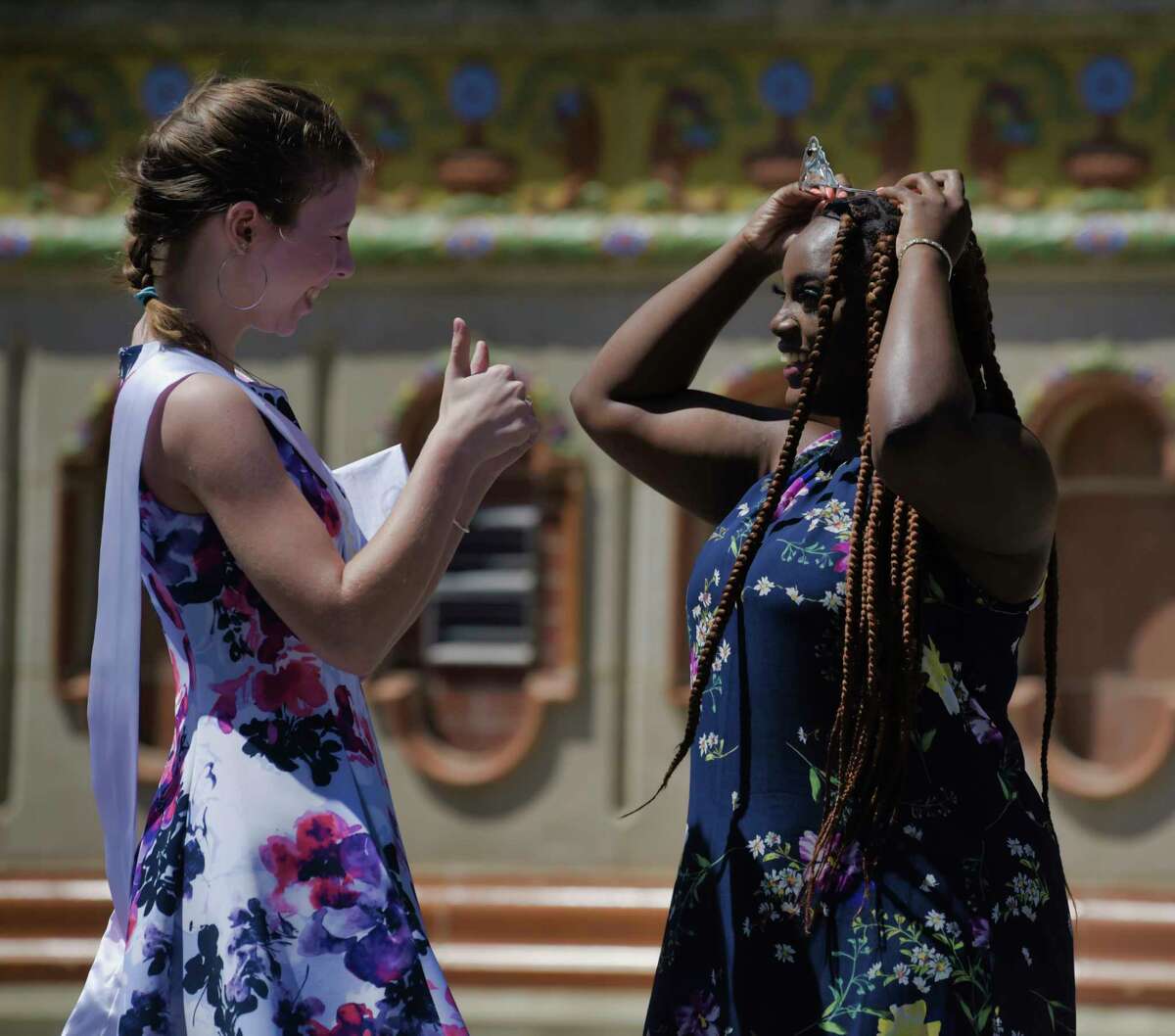 The 2020 Tulip Queen, Kaya Rifenberg-Stempel, left, celebrates with the 2021 Tulip Queen, Ashanti Bishop, after handing over her crown to Bishop during an event at Washington Park on Sunday, June 13, 2021, in Albany, N.Y. The 2022 crowning will take place in Washington Park on May 7 at noon. (Paul Buckowski/Times Union)