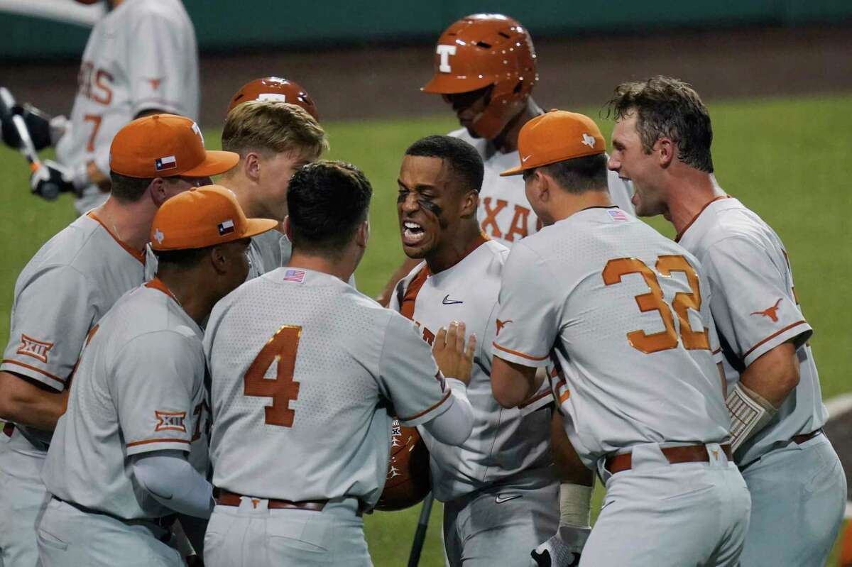 Texas’ Cam Williams, center, celebrates a two-run homer against South Florida during the seventh inning of Game 2 of the NCAA Austin Super Regional on Sunday, June 13, 2021.