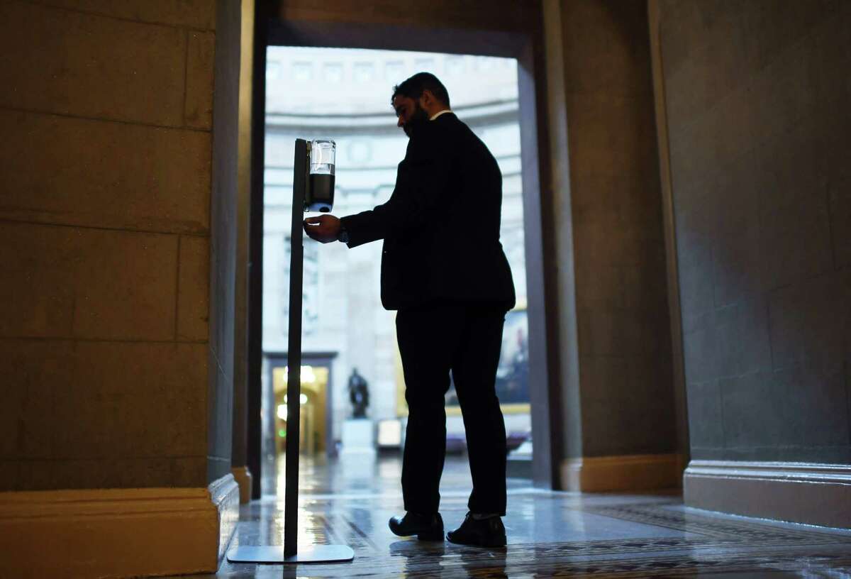 A man uses a hand sanitizer dispenser outside the United States Capitol Rotunda on June 10, 2021 in Washington.
