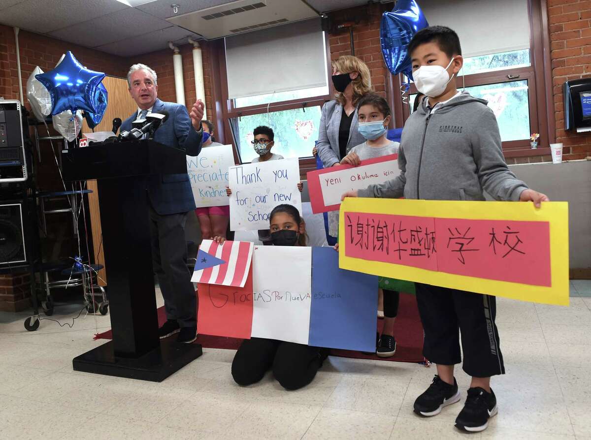 West Haven Superintendent of Schools Neil Cavallaro, left, speaks during a press conference announcing $24 million in funding toward the cost of a new Washington Elementary School in West Haven on June 14, 2021. At right is third-grader Chenxi Dong.