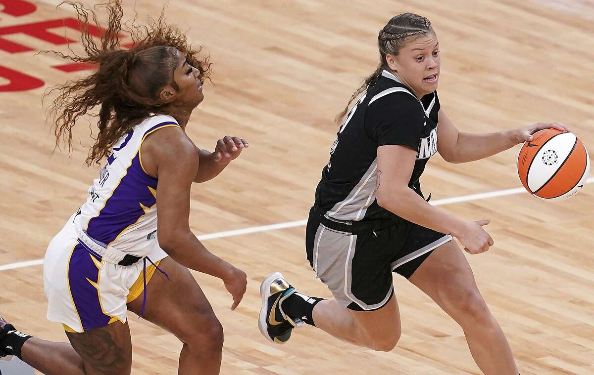 Minnesota Lynx guard Rachel Banham (15) dries past Los Angeles Sparks guard Te'a Cooper (2) during the first quarter of a WNBA basketball game Saturday, June 12, 2021, in Minneapolis. (Anthony Souffle/Star Tribune via AP)