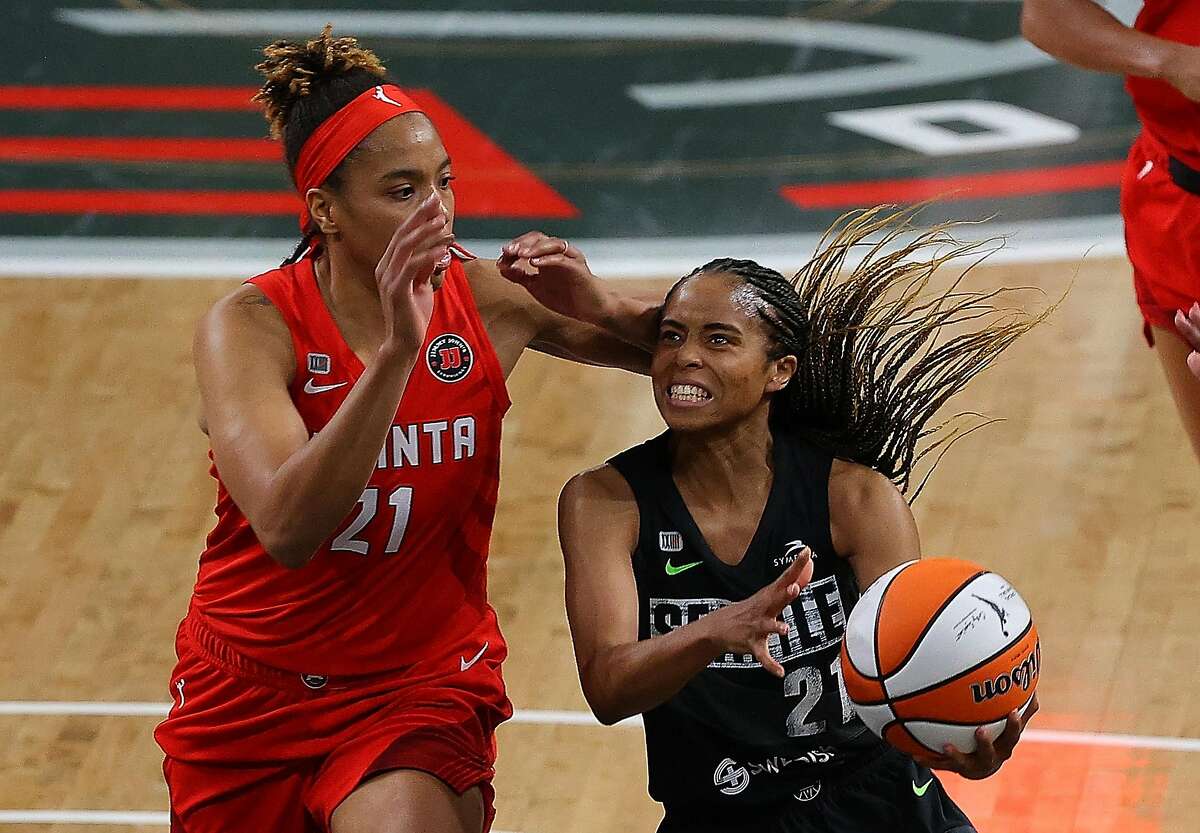 COLLEGE PARK, GEORGIA - JUNE 09: Jordin Canada #21 of the Seattle Storm drives against Tianna Hawkins #21 of the Atlanta Dream in the second half at Gateway Center Arena on June 09, 2021 in College Park, Georgia. (Photo by Kevin C. Cox/Getty Images)