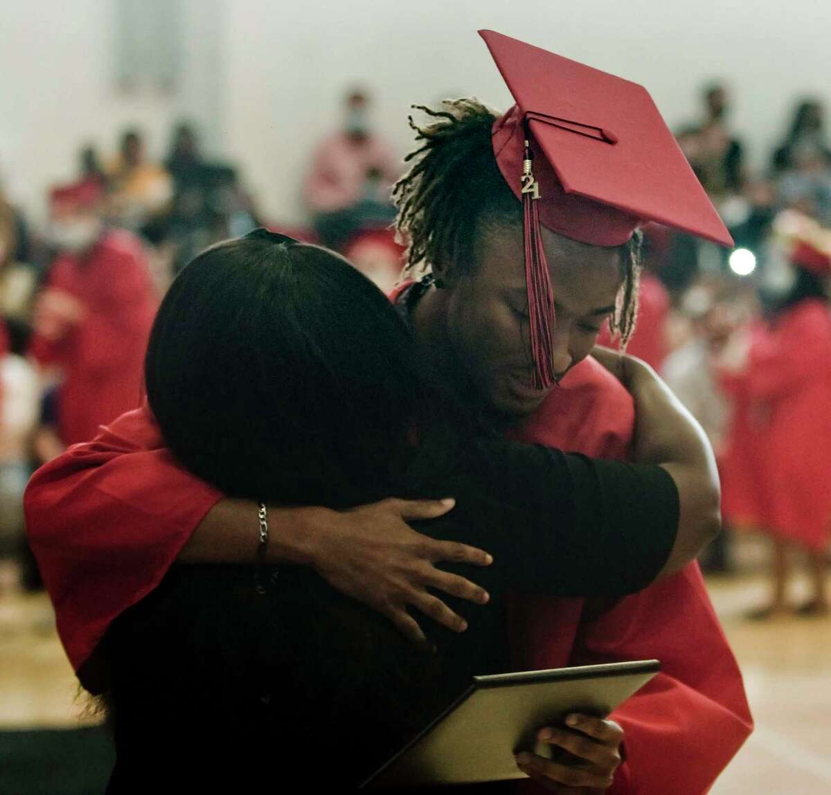 Anthony Roberts gets a hug at the JM Wright Technical High School graduation. Monday, June 14, 2021
