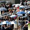 2019: Racegoers take shelter from the rainstorm.