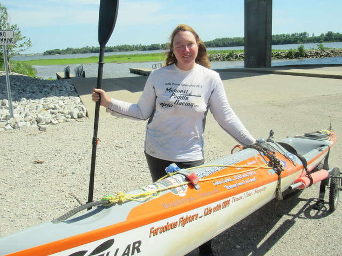 Competitive kayaker Traci Lynn Martin, of Kansas City, Missouri, stands beside her kayak Monday in Alton. Martin is on a quest to set a world record for the fastest time a solo female kayaker to travel the Mississippi River.