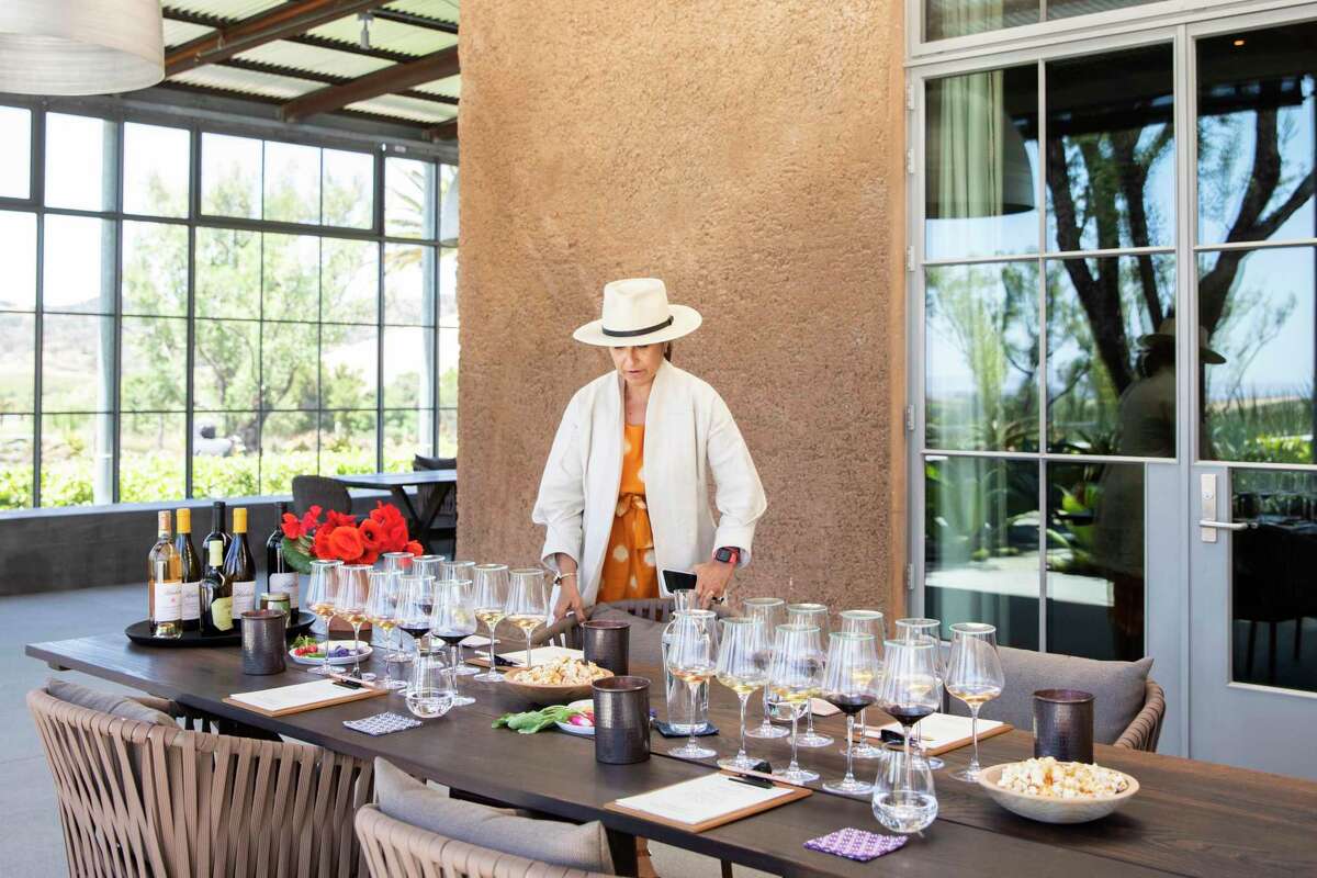 An ‘elevated’ wine tasting in Napa now costs $82 per person on average, data shows. Hudson Ranch Vineyards co-owner Cristina Hudson sets up a group tasting at the winery.