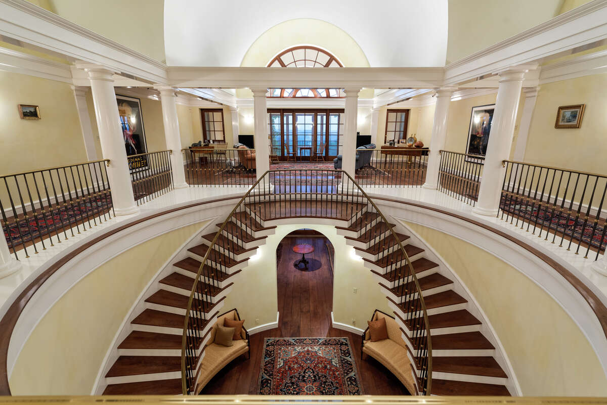 The home's foyer has a two-story double staircase that leads up to the second floor.
