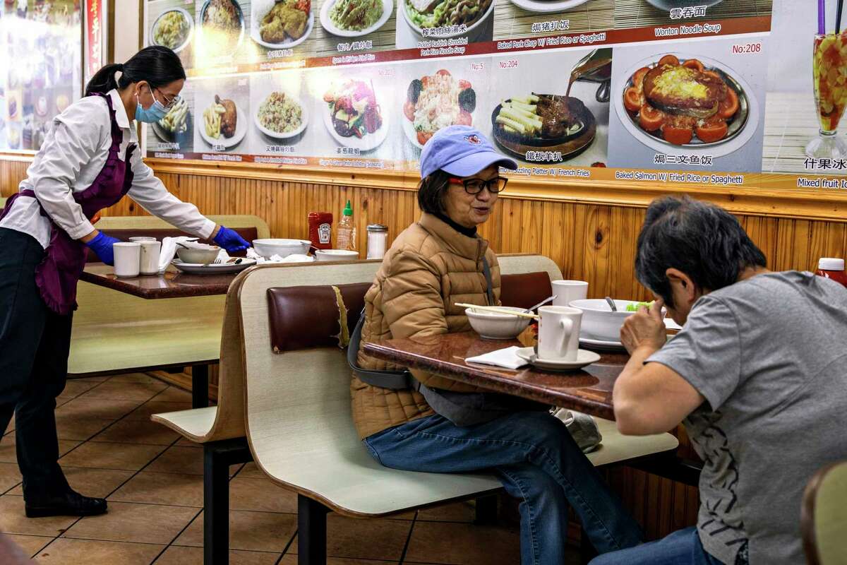 May Tam (center) enjoys a meal with Connie Yu at VIP Cafe in San Francisco’s Chinatown, where cautious optimism lingered among bustling corridors.