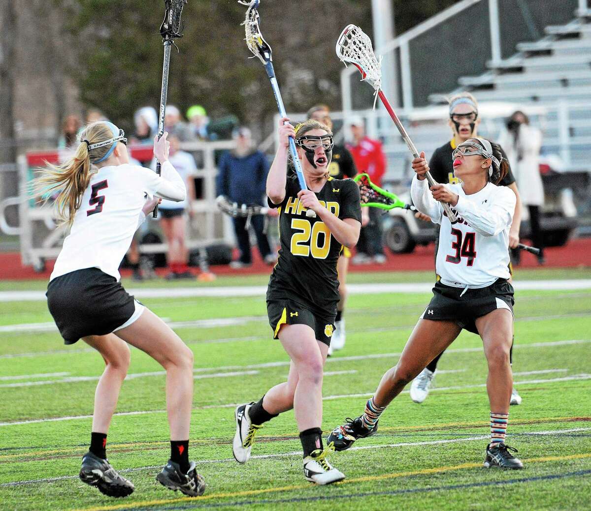 A hand in Lauren Cole shoots when Cheshire's Erica Stauffer, on the left, and Kya O'Donnell defend in 2014.