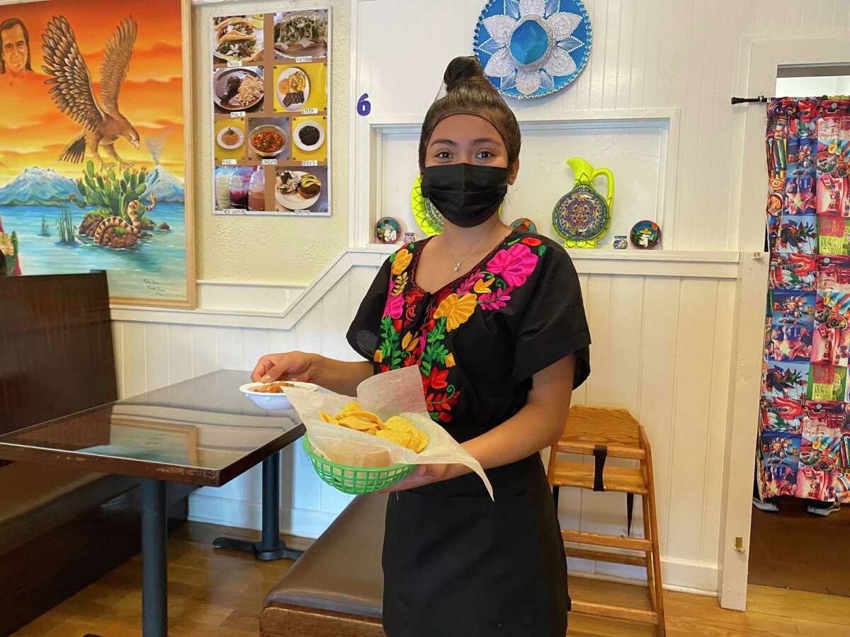 A waitress serving tacos