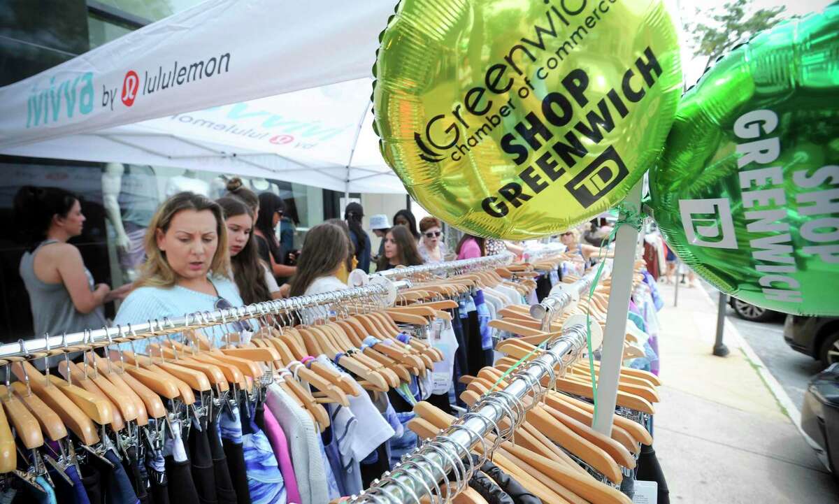Shoppers hunt for bargains from local retailers as they stroll up and down Greenwich Avenue during the Chamber of Commerce Sidewalk Sales Day in Greenwich, Conn. on July 11, 2019.