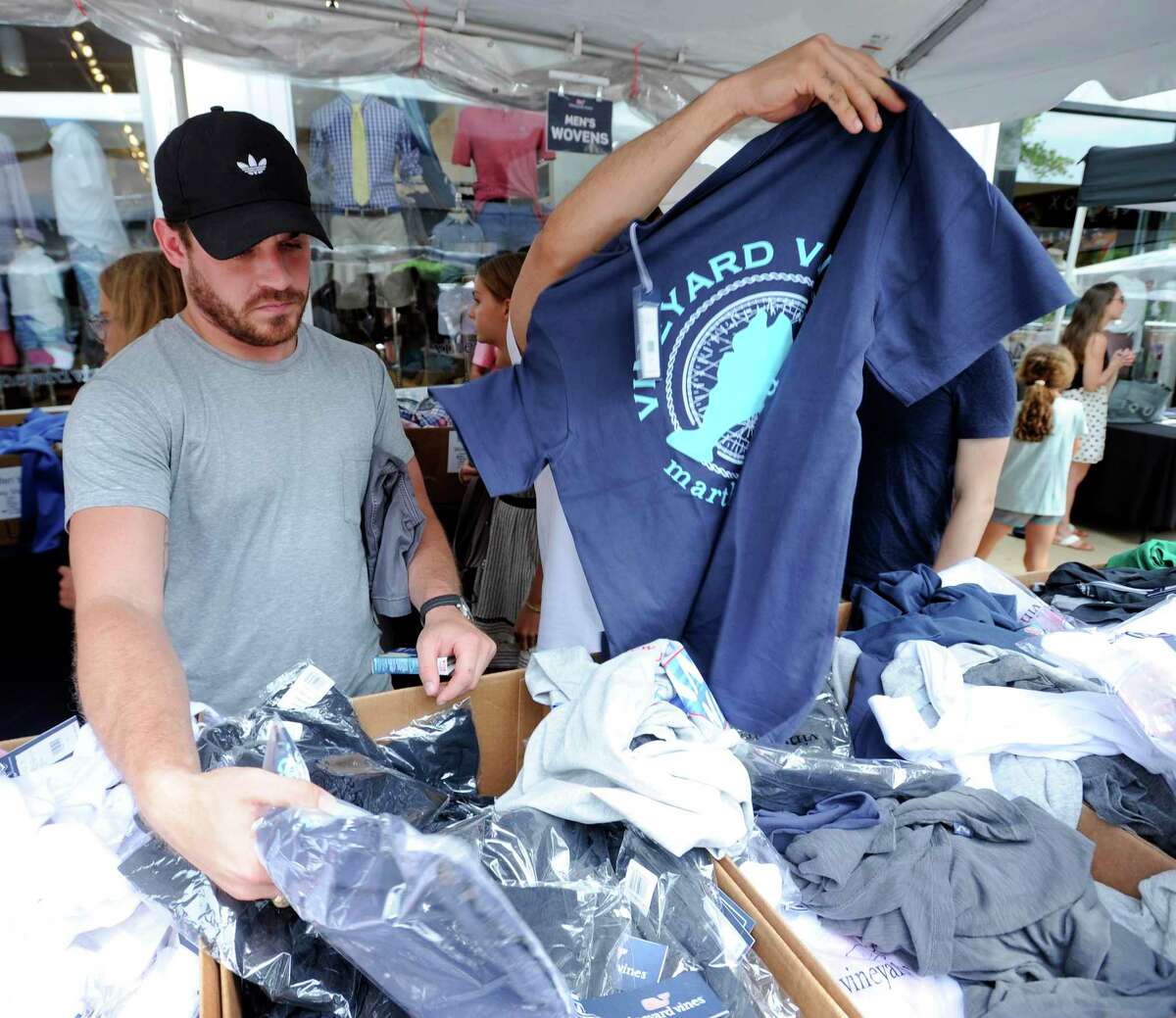 Austin West of Dallas hunts for a bargain at Vineyard Vines as he shops local retailers during the Chamber of Commerce Sidewalk Sales Day in Greenwich, Conn. on July 11, 2019.