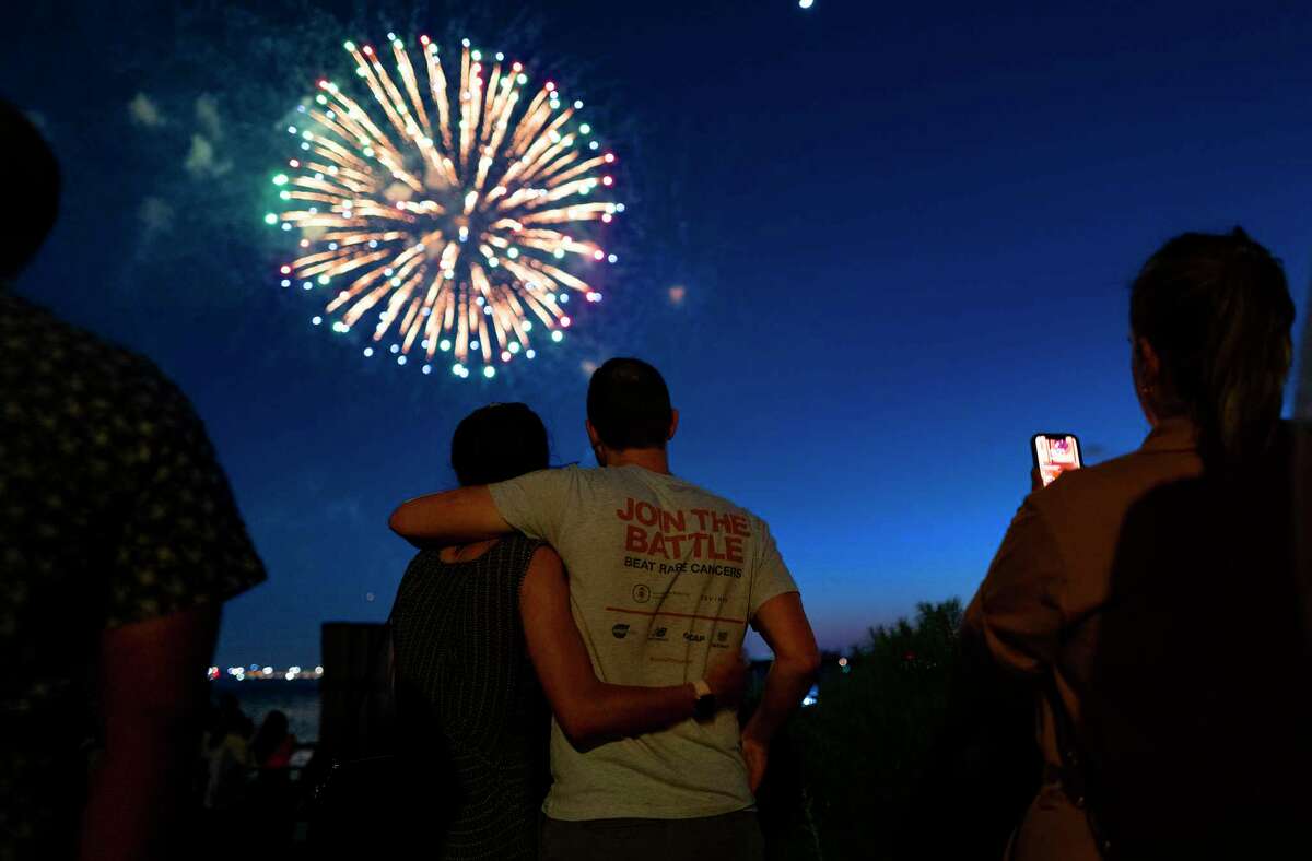 People watch as fireworks explode over New York Harbor as New York and other cities around New York state recognize a rate of 70% for single dose vaccinations against the COVID-19 virus, Tuesday, June 15, 2021 in New York. Celebration of the milestone was announced by Gov. Andrew Cuomo earlier in the day.