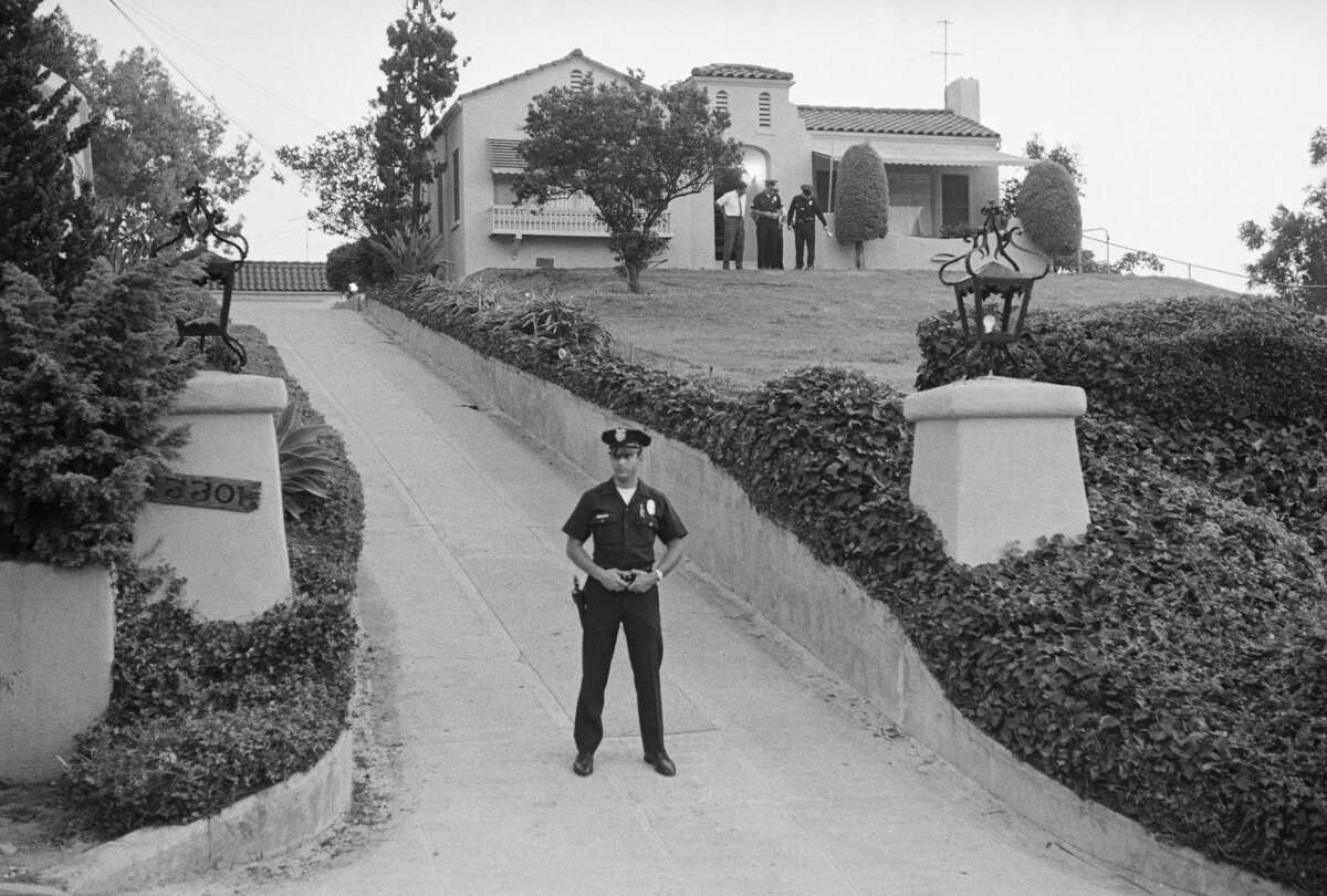 A police officer blocks the driveway at 3311 Waverly Drive, Los Angeles, August 10, 1969.