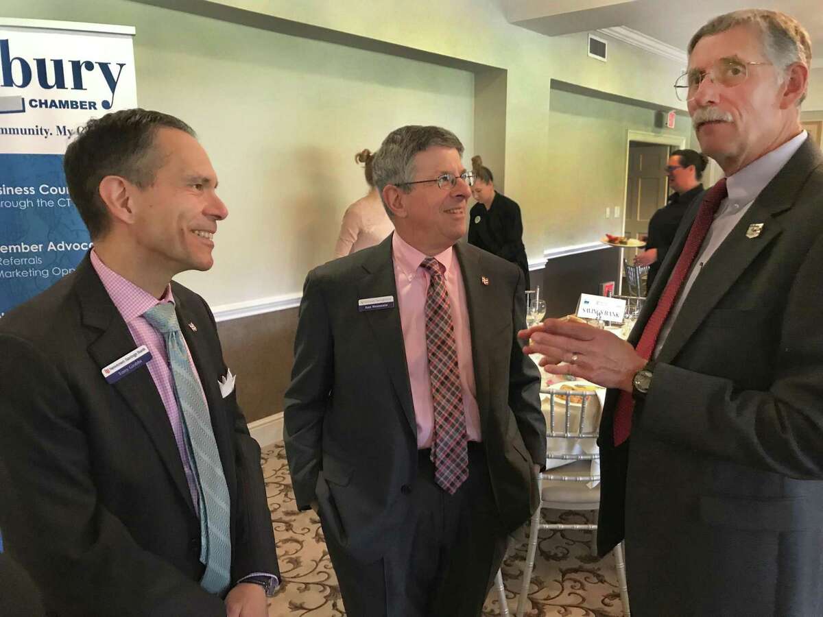 File photo. Economist Don Klepper-Smith, right, speaks with Tony Giobbi and Ken Weinstein of Newtown Savings Bank during the Greater Danbury Chamber of Commerce's 2018 Economic Forecast Breakfast held Tuesday, April 17, 2018, at Ridgewood Country Club in Danbury, Conn.