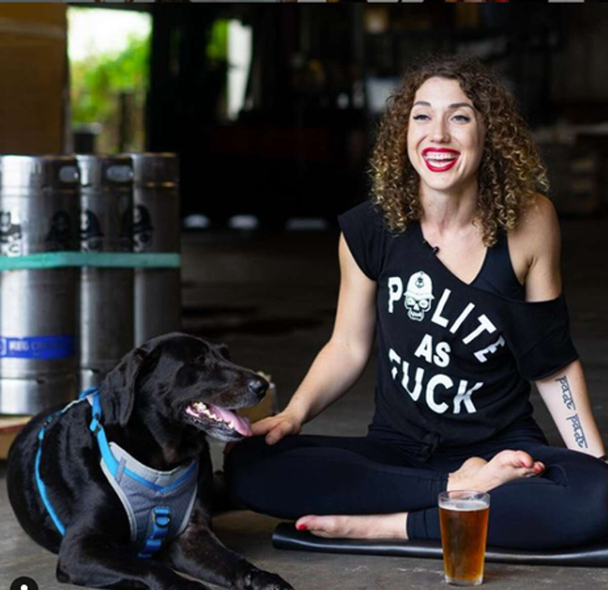 Wearing a T-shirt that expresses some of rage yoga philosophy, Ashley Duzich and her dog are ready for a rage yoga session.
