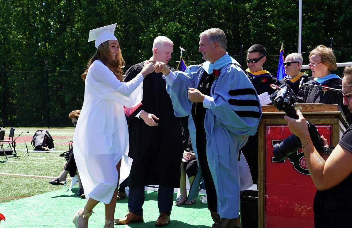 Luizzi fist bumped Shannon Jordan, a member of the New Canaan Class of 2021 during the commencement ceremony.