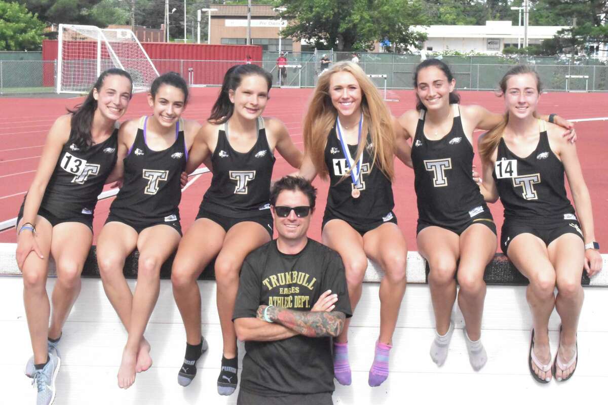 Calyn Carbone, Evelyn Marchand, Abigail Poplawski, head coach Jim McCaffrey, Kali Holden, Brenna Asaro and Ella Consla get together at the CIAC Steeplechase competition.