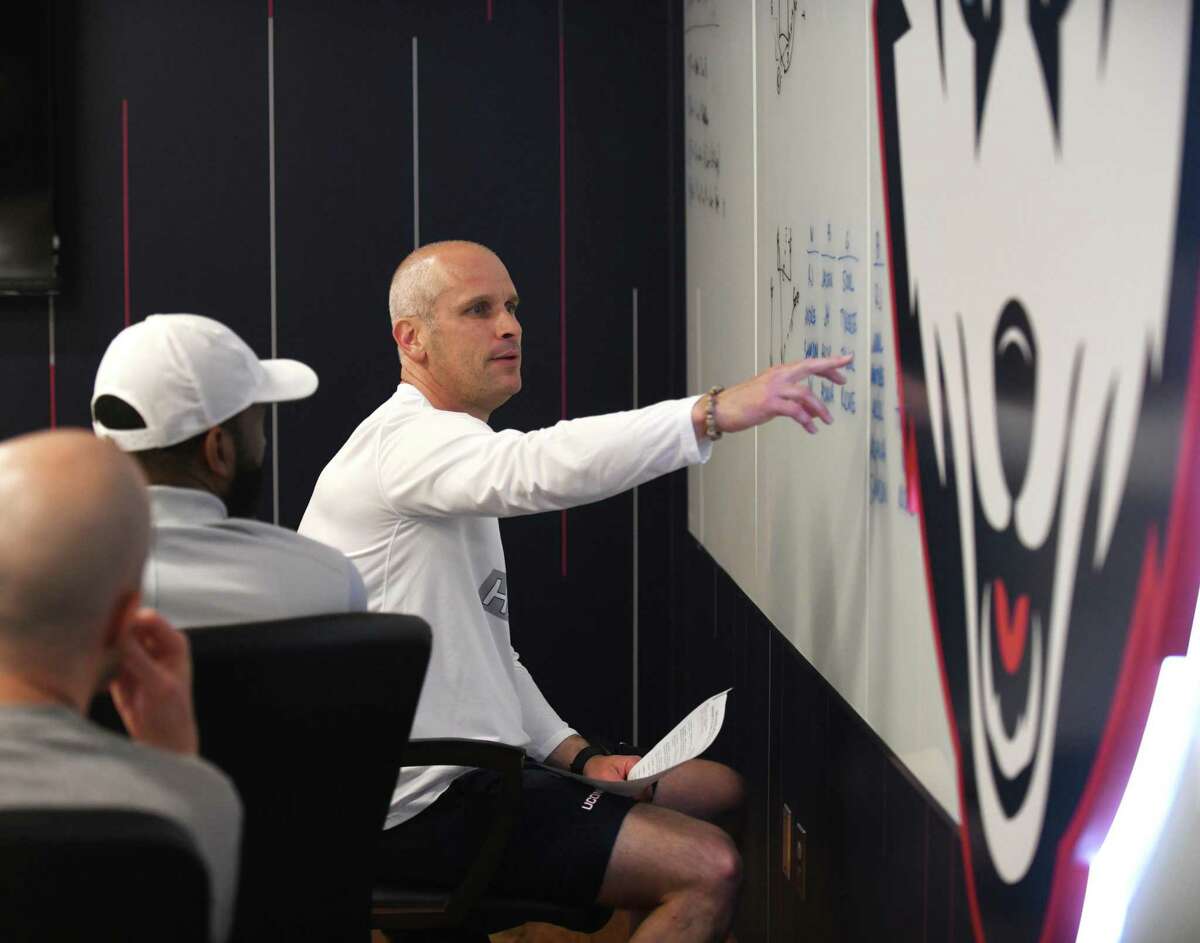 UConn men's basketball coach Dan Hurley leads a meeting with assistant coaches before practice at the Werth Family UConn Basketball Champions Center on the UConn main campus in Storrs, Conn. Wednesday, June 9, 2021.