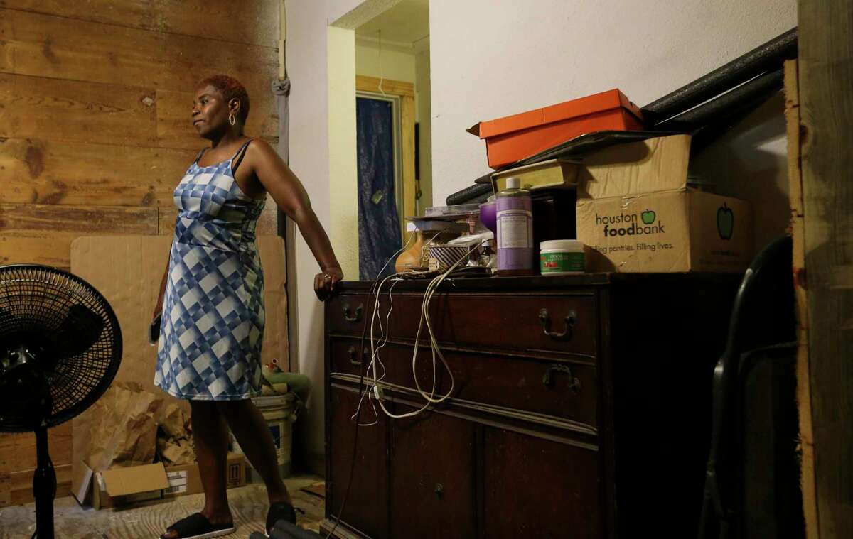 Sandra Edwards, 55, shows the interior of her steamy house Wednesday, June 16, 2021, at in Houston. The house was flooded during Hurricane Harvey, and it is still going through rebuilding. Before Harvey, she had air conditioning system installed in the house, but now she only has a window unit air conditioner. "I'm basically confined in (that) room," she said.