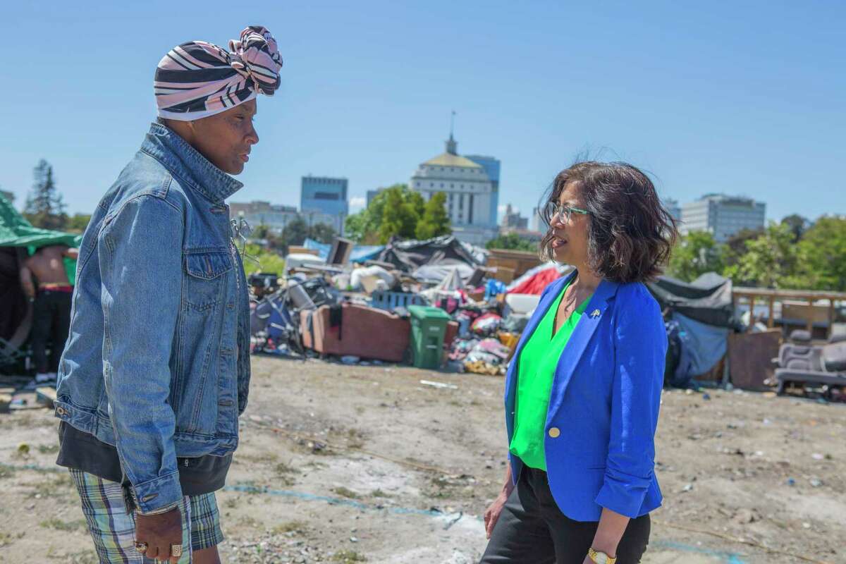 City Council Member Nikki Fortunato Bas speaks with Krystal, a resident of an encampment near Lake Merritt, in June 2021. The site might now be used for an affordable housing development.