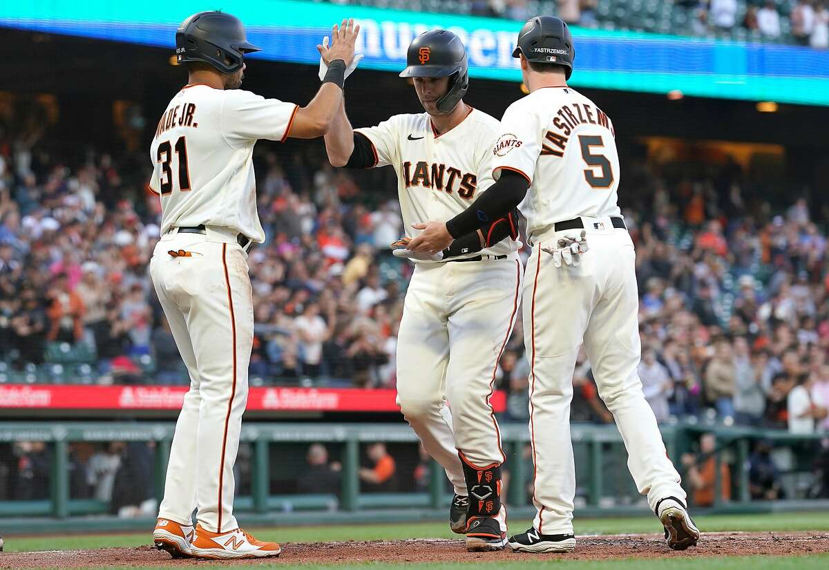SAN FRANCISCO, CALIFORNIA - JUNE 16: Buster Posey #28 of the San Francisco Giants is congratulated by LaMonte Wade Jr #31 and Mike Yastrzemski #5 after hitting a three-run home run against the Arizona Diamondbacks in the bottom of the first inning at Oracle Park on June 16, 2021 in San Francisco, California. (Photo by Thearon W. Henderson/Getty Images)
