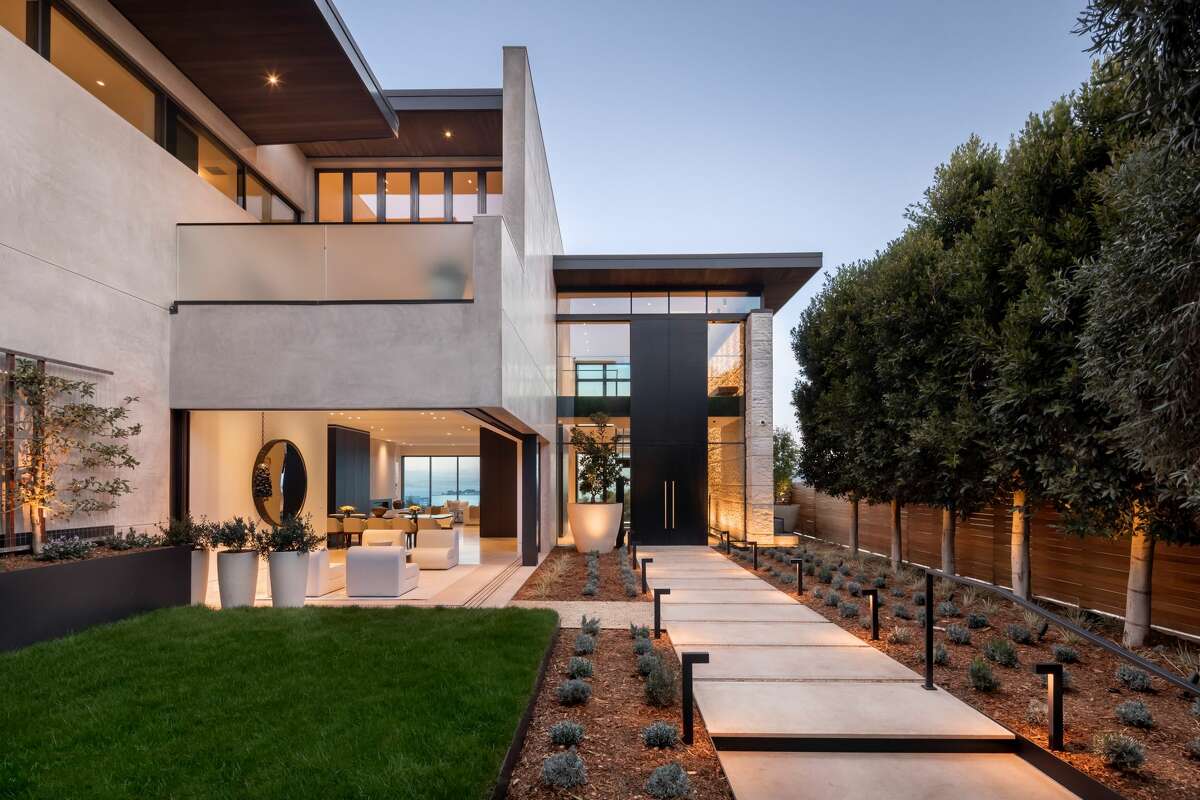 If the dimensions seem impressive, they are: A 19-foot tall motorized entry door fully slides away to a two-story open atrium with a 30-foot-long feature wall. 