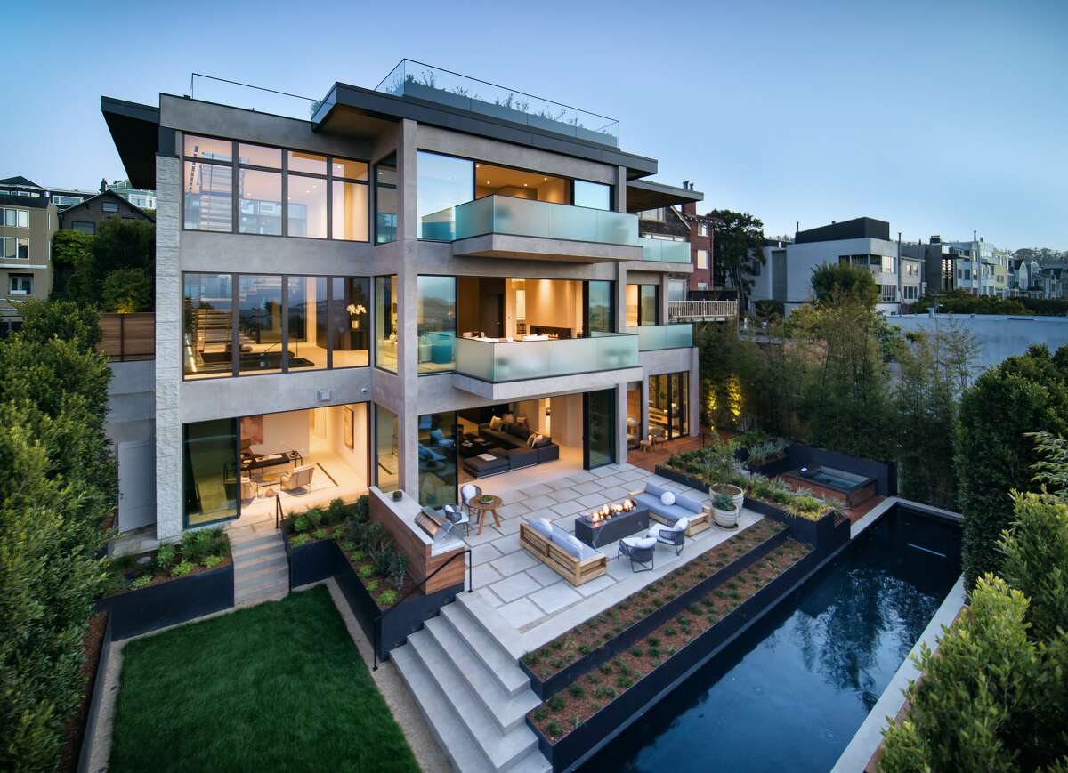 This view from the backside of the newly constructed home highlights the seamless indoor/outdoor flow of its design.