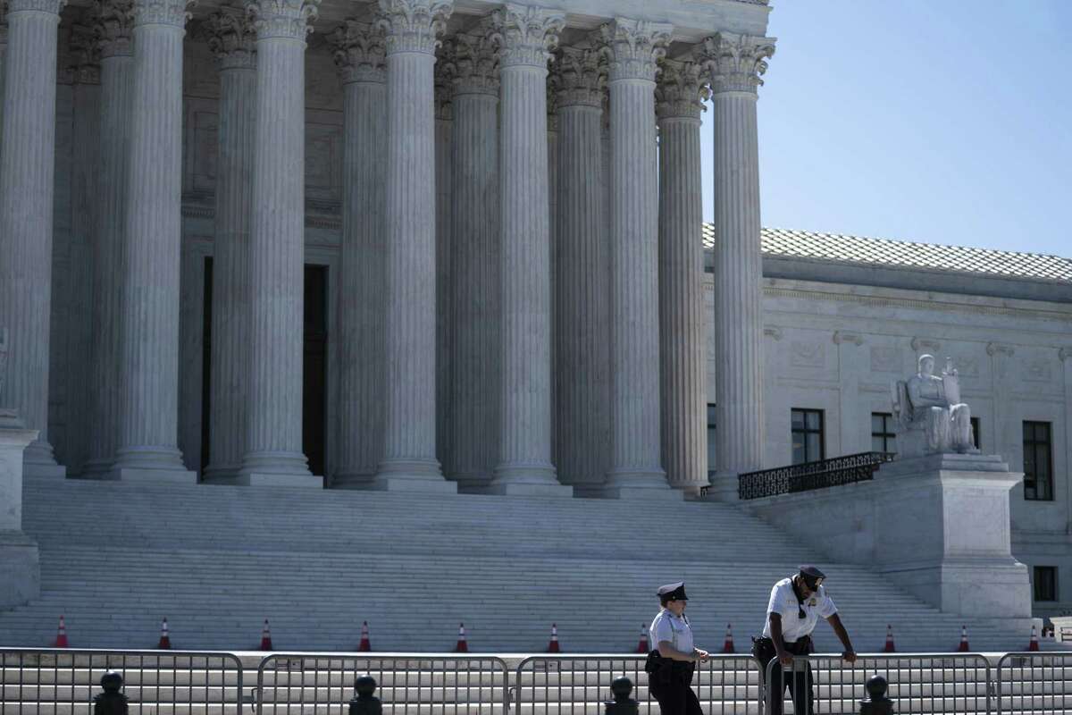 U.S. Supreme Court police officers stand outside in Washington, D.C., on June 17, 2021.