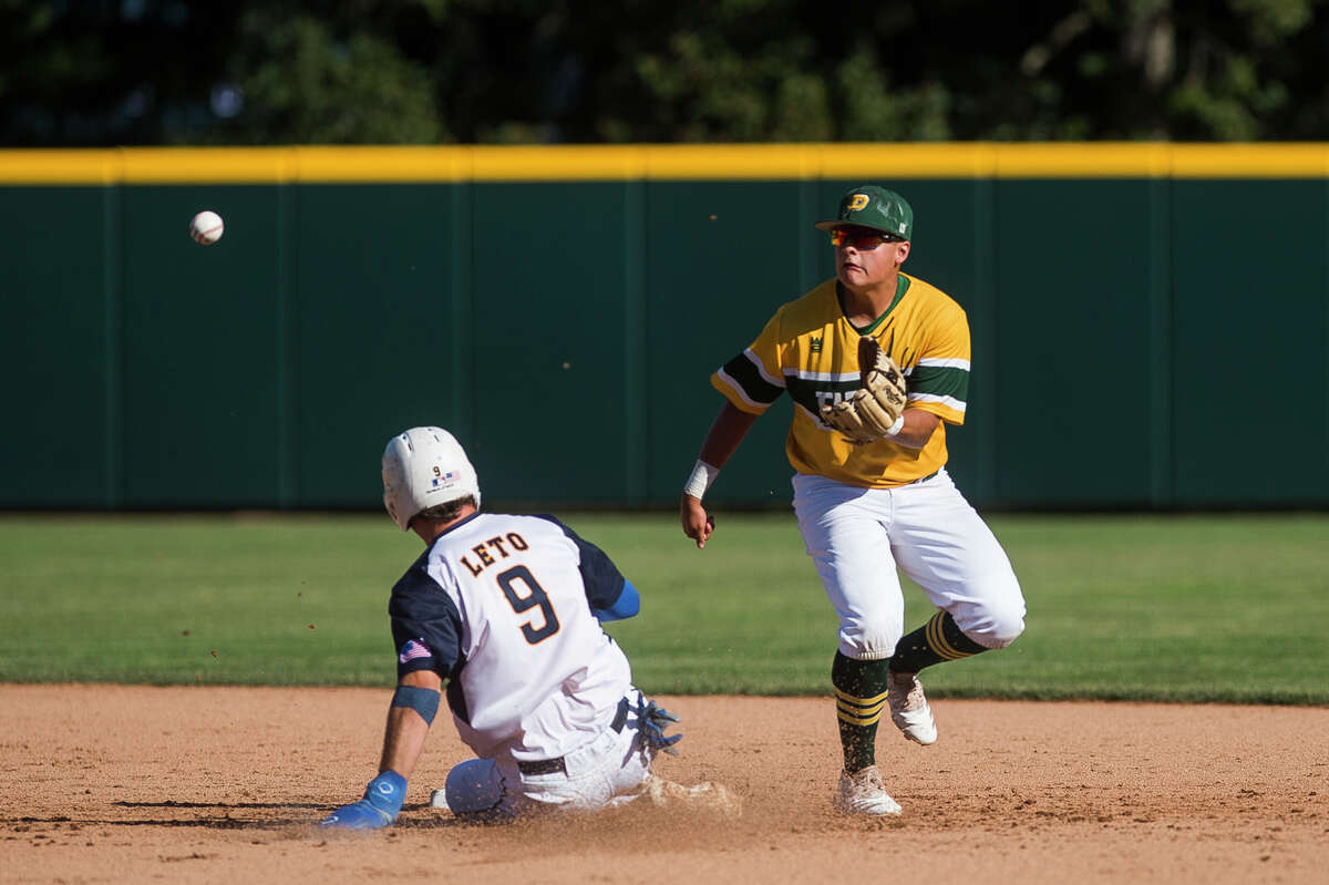 Dow's Logan McCoy reaches out to catch the ball while a runner slides into second base during the Chargers' Div. 1 state semifinal loss to Portage Central Thursday, June 17, 2021 at McLane Stadium in East Lansing. (Katy Kildee/kkildee@mdn.net)