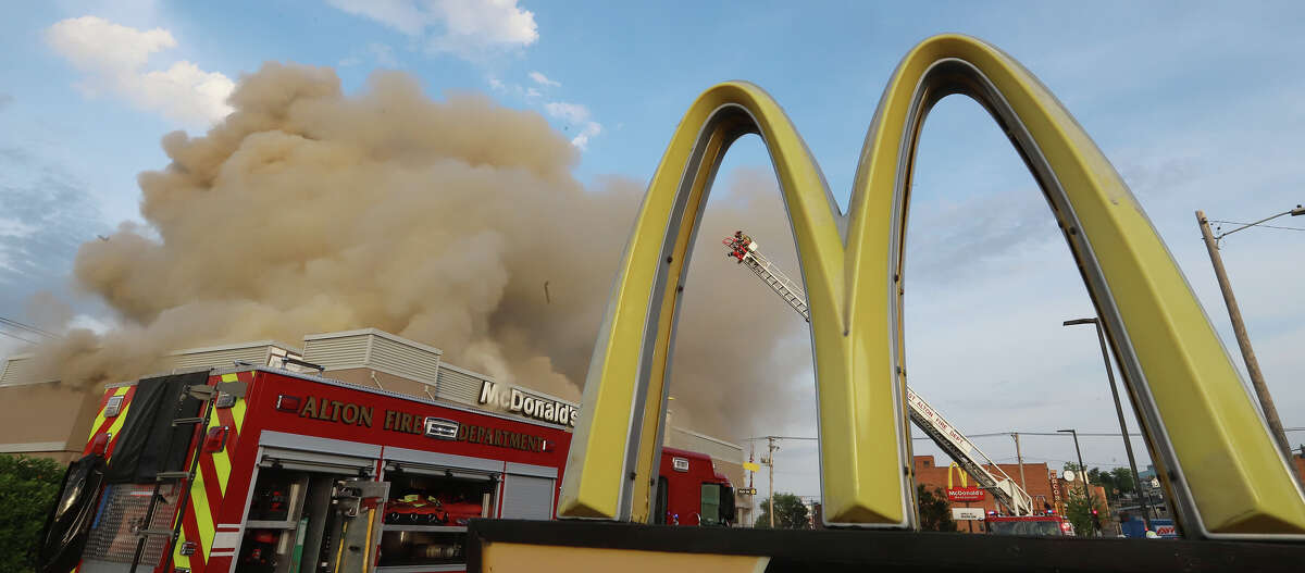 Clouds of smoke billow from the downtown Alton McDonalds, Thursday, June 17. The roof collapsed and firefighters believe the fire began with an AC unit.