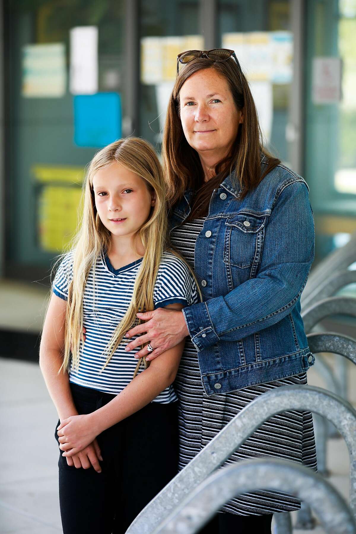 (L-r) Brooklynn Conway, 10 and her mother Jennifer Conway stand outside Bayside Martin Luther King Jr. Academy where she will be going to school in Marin City, California on Friday, June 11, 2021.
