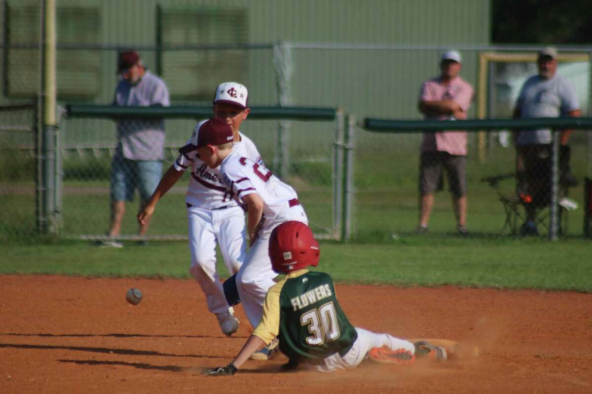 League City American's defense up the middle in shortstop Spencer Orsini (10) and second baseman Jackson Dempsey can't find the handle on this throw from their catcher as a Santa Fe runner advances to second.