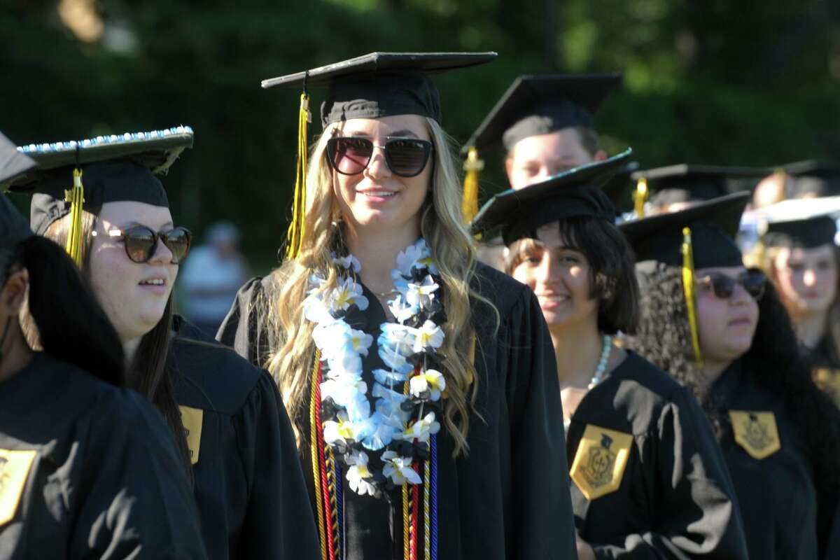 Graduates line up to receive their diplomas during graduation for the Trumbull High School Class of 2021 on Thursday.