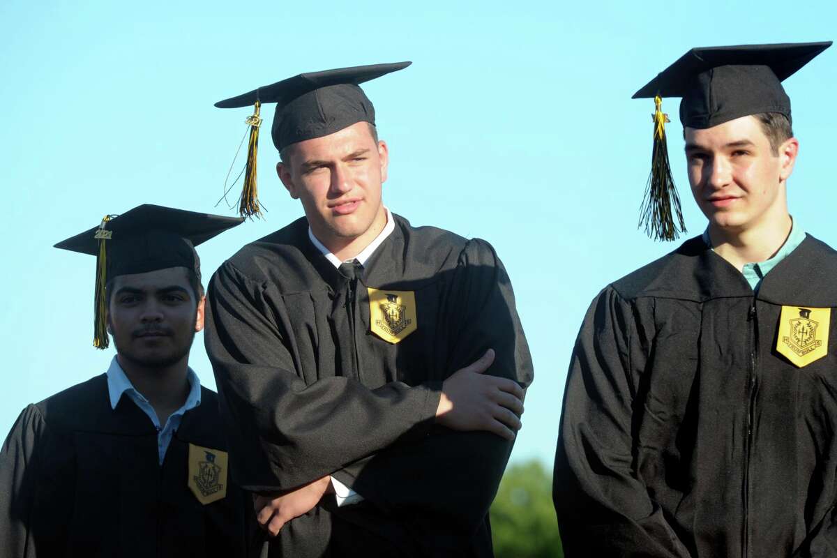 Graduates line up to receive their diplomas during graduation for the Trumbull High School Class of 2021, in Trumbull, Conn. June 17, 2021.