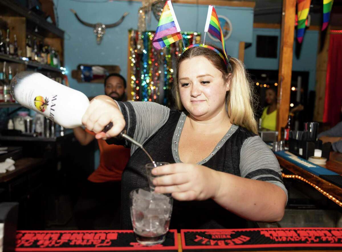 Emily Nelson mixes a drink at the Ranch Hill Saloon, Saturday, June 5, 2021, in Spring. The bar will feature a variety of events for this year's pride season.