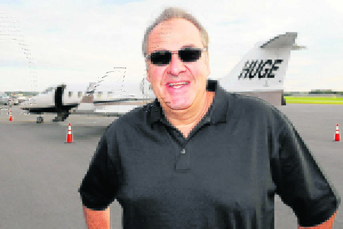 Auto dealer Billy Fuccillo stands in front of his corporate jet at the Albany International Airport in Colonie, New York September 16, 2008.