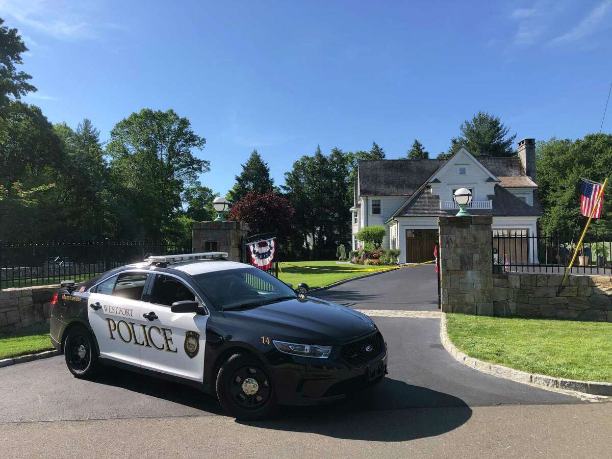A police cruiser on Friday parked in front of the Westport, Conn., home where a woman and a 7-year-old were found dead on Thursday, June 17, 2021.