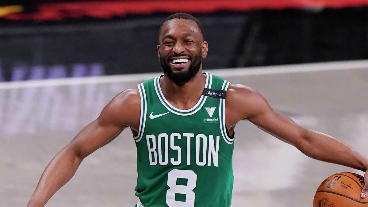 Boston Celtics guard Kemba Walker (8) laughs as he takes the ball up court during the second quarter of Game 2 of an NBA basketball first-round playoff series against the Brooklyn Nets, Tuesday, May 25, 2021, in New York. (AP Photo/Kathy Willens)