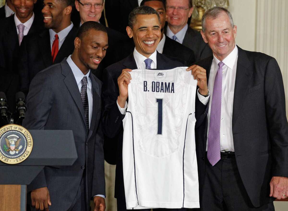 WASHINGTON, DC - MAY 16: U.S. President Barack Obama (C) holds up a jersey while posing for photographs with 2011 NCAA Champion University of Connecticut men's basketball coach Jim Calhoun (R) and team guard Kemba Walker at the White House May 16, 2011 in Washington, DC. UConn earned the national championship with an 11-game run through the postseason, ending with a 53-41 win over Butler in the NCAA title game. (Photo by Chip Somodevilla/Getty Images)