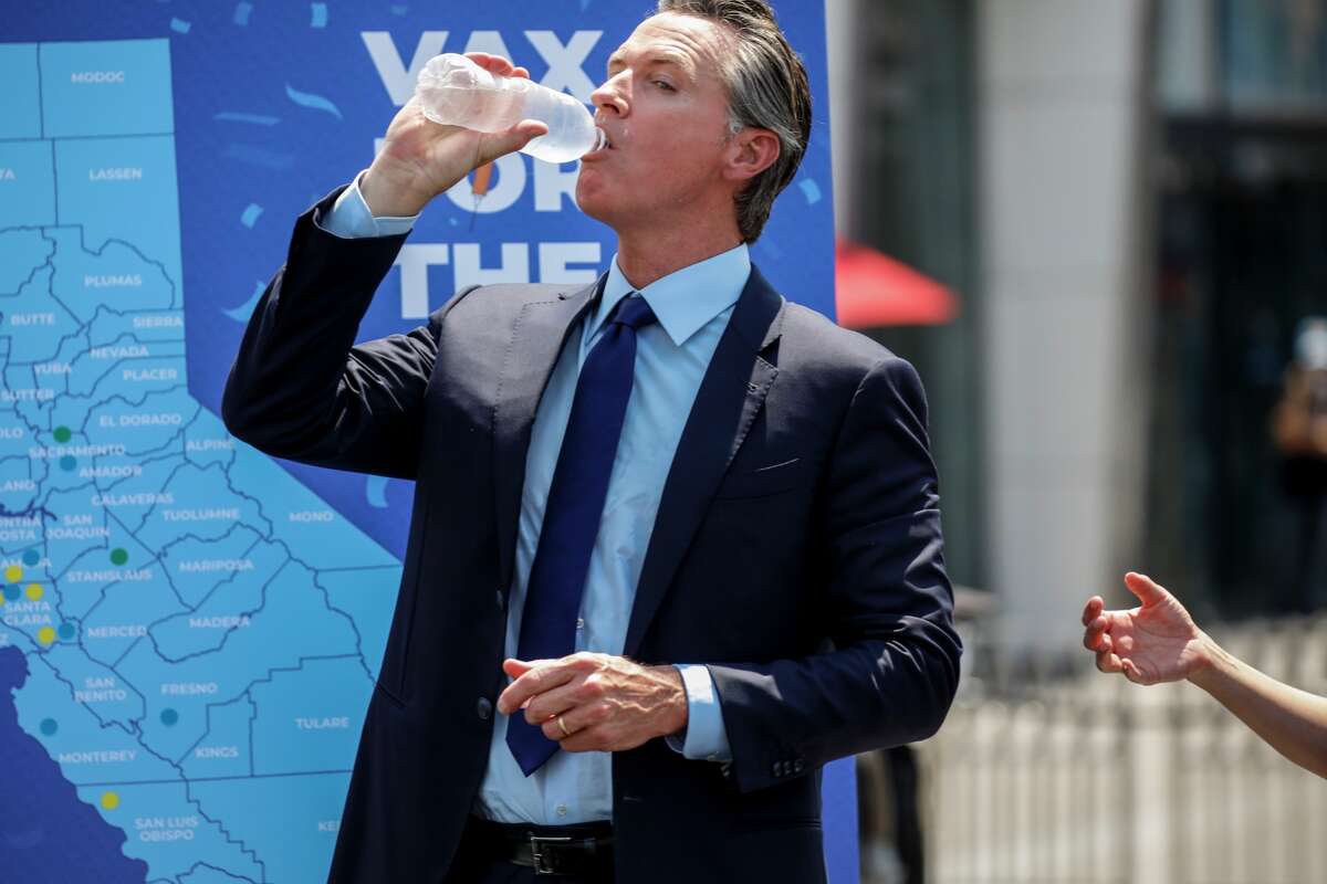 Gov. Gavin Newsom drinks some water at Universal Studios Tuesday, June 15, 2021 during the final cash prize drawing in the state's Vax for the Win program.