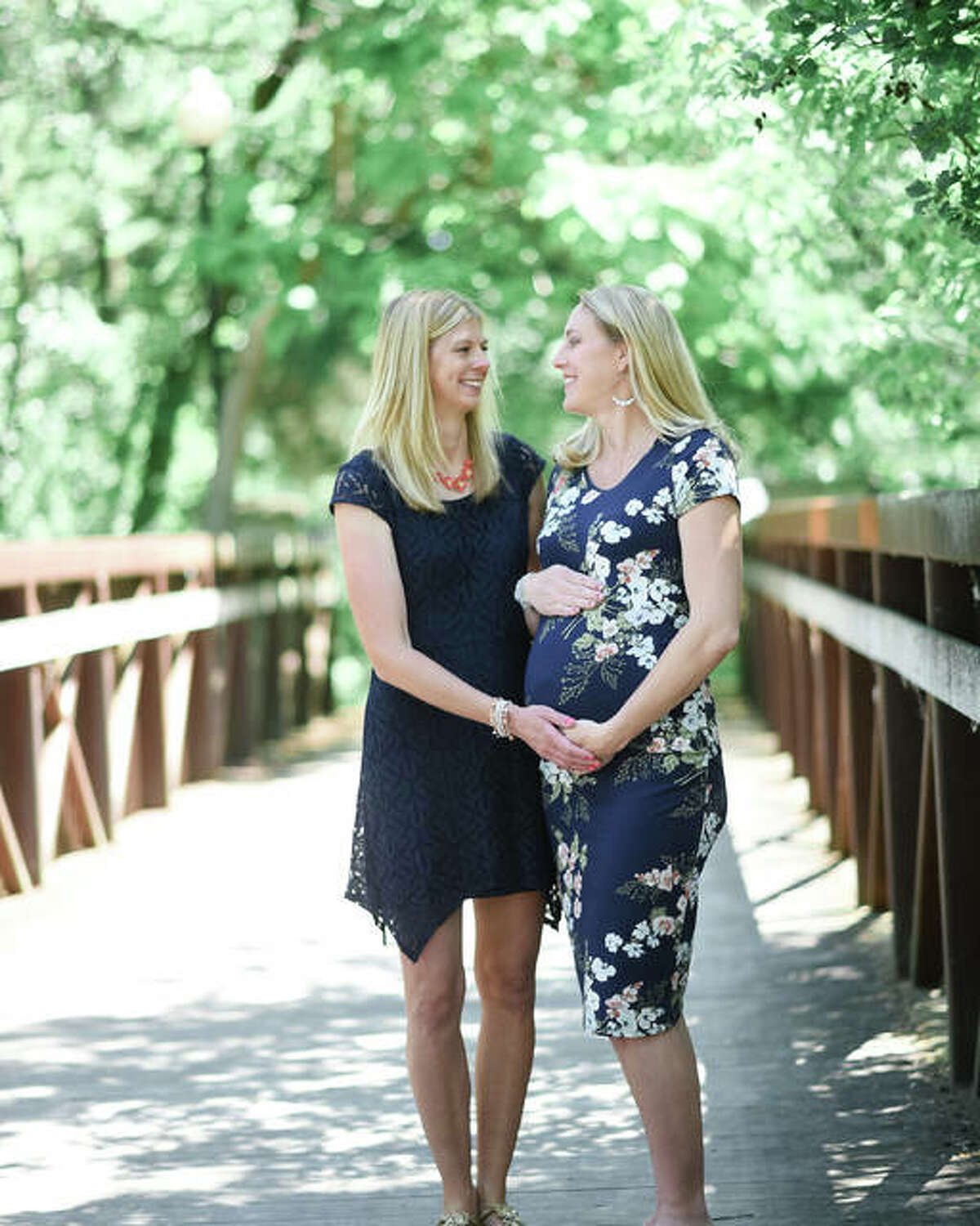 Edwardsville’s Kristin Stahlheber, right, with her sister, Megan Glassman, of Plainfield. Stahlheber, who is eight months pregnant, is serving as a surrogate for her sister, who is no longer able to have children due to heart issues.