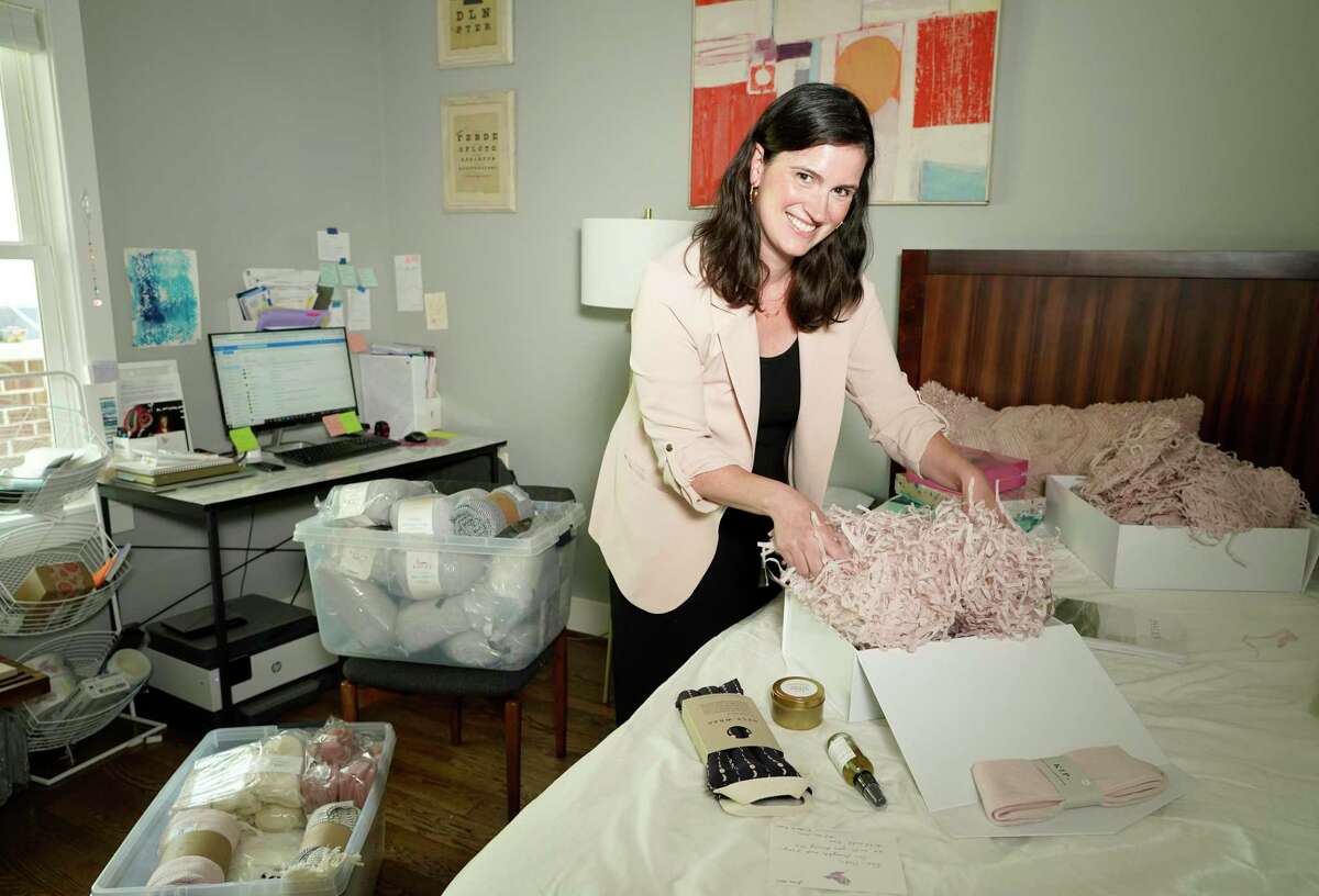 Serena Houlihan, co-founder of Le Wren, prepares to pack a gift box Wednesday, June 16, 2021 in Houston. Le Wren was created by two women, in honor of their mothers' battles with cancer. She is currently using her guest room until Le Wren moves into a larger space this summer.