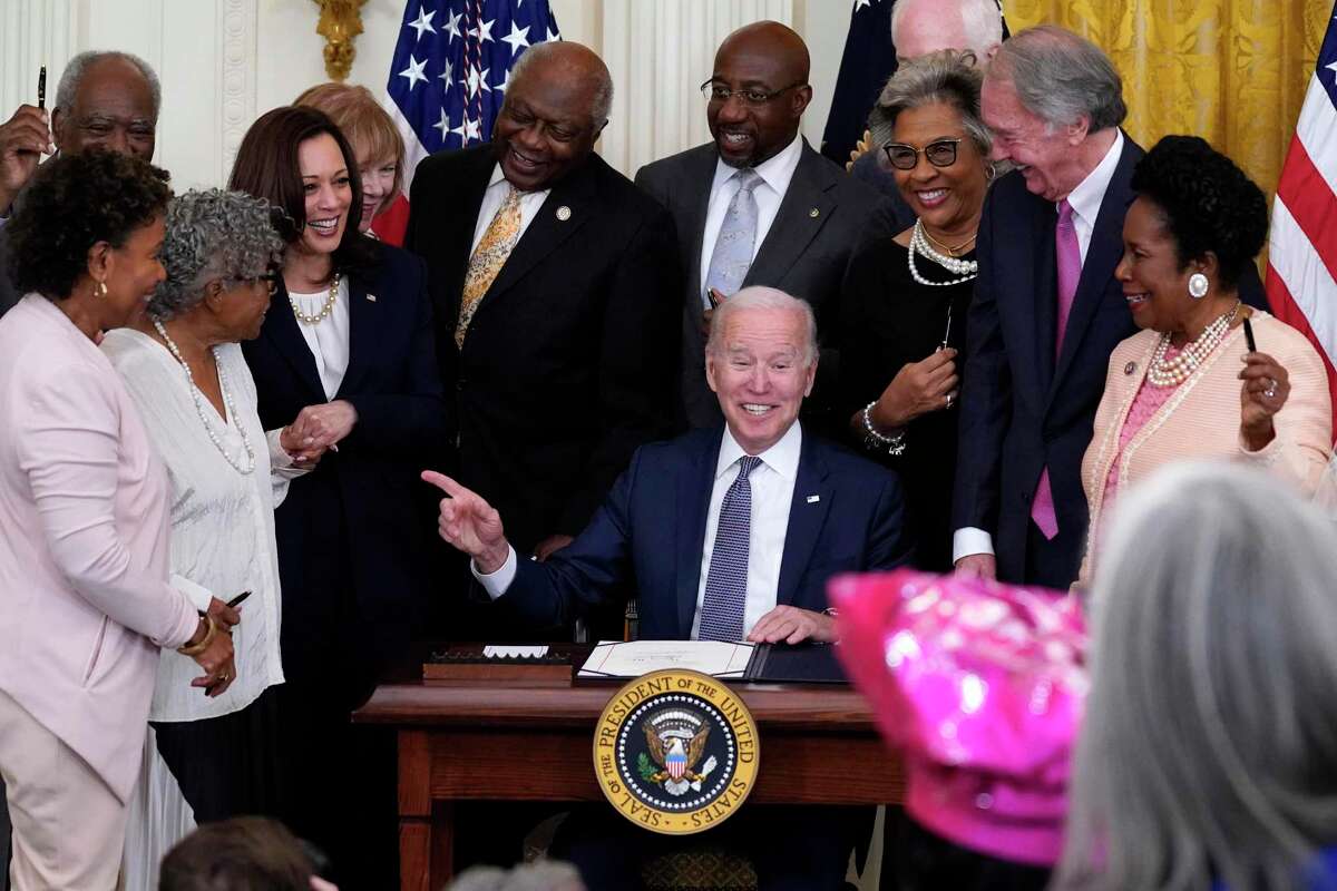 President Joe Biden points to Opal Lee after signing the Juneteenth National Independence Day Act Thursday.