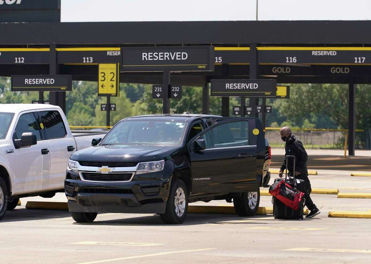 A person gets into a vehicle at Hertz, 8100 Monroe Road, at Hobby Airport Friday, June 18, 2021 in Houston.