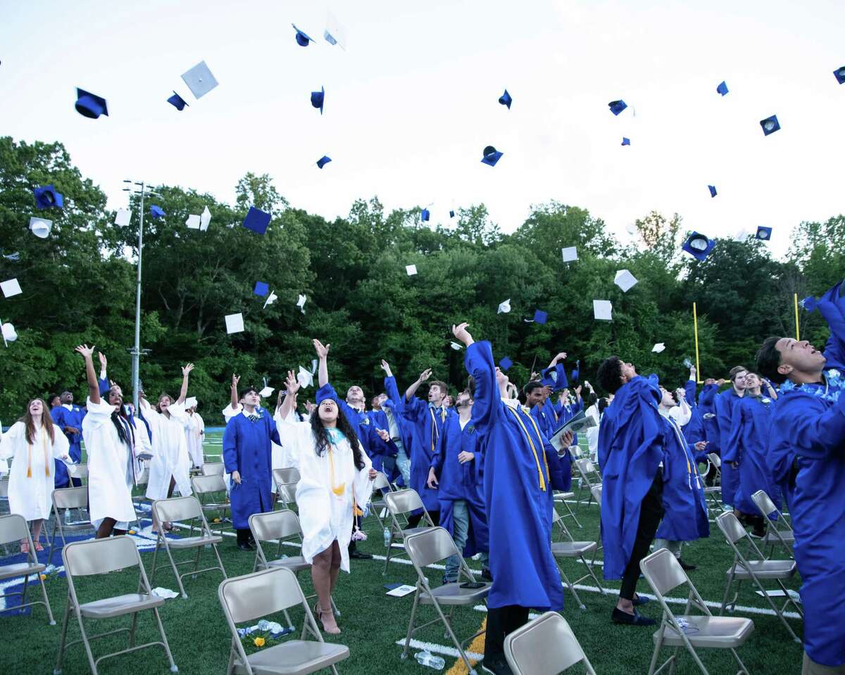 Members of Bunnell High School’s Class of 2021 toss their caps at the end of commencement ceremonies June 16, 2021.