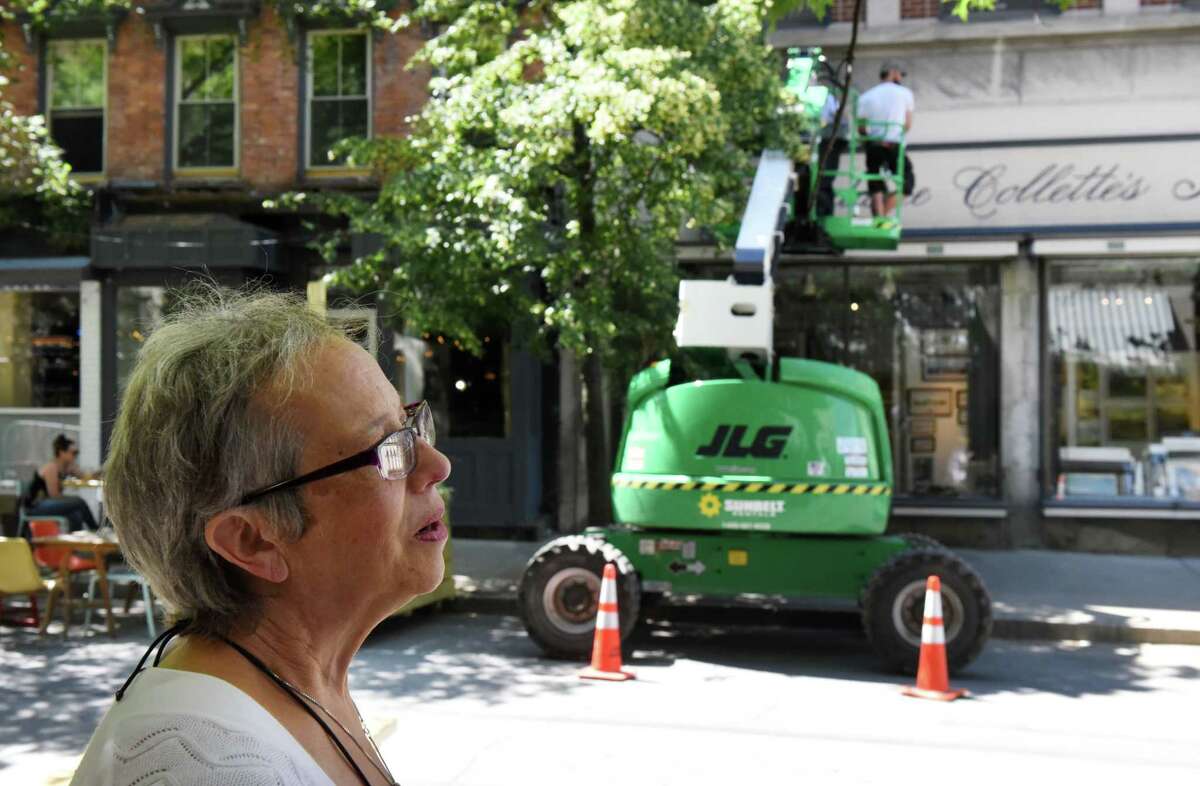 Kathy Sheehan, historian for the city of Troy and for Rensselaer County based at the Hart Cluett Museum, stands on Broadway at Monument Square where movie crews for 'The Gilded Age' remove what's left of the massive period set on Friday, June 18, 2021, in Troy, N.Y. (Will Waldron/Times Union)