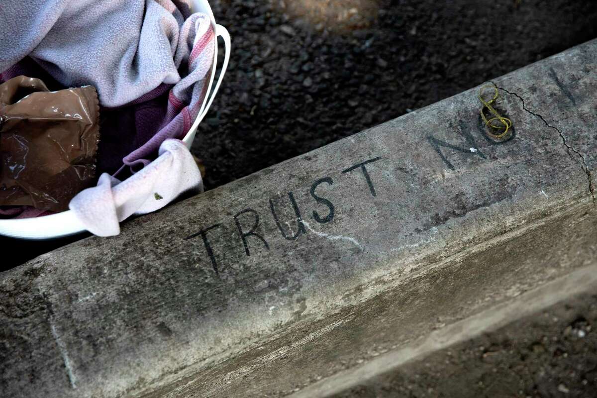 The words ‘Trust No’ are written at the edge of the District 1 Field Office where former city councilman Robert Trevino had let unsheltered people camp.