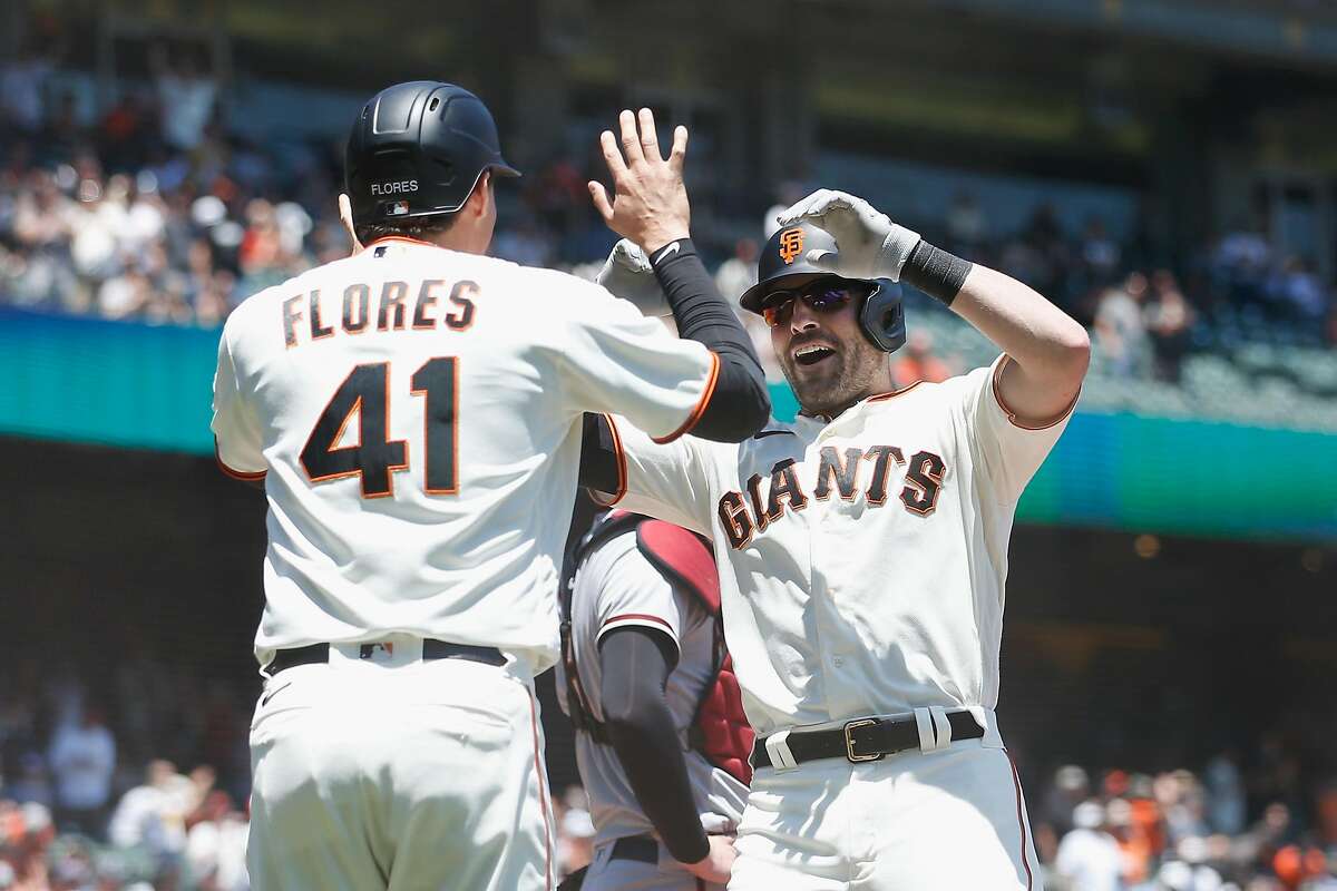 SAN FRANCISCO, CALIFORNIA - JUNE 17: Curt Casali #2 of the San Francisco Giants celebrates with Wilmer Flores #41 after hitting a two-run home run in the bottom of the second inning at Oracle Park on June 17, 2021 in San Francisco, California. (Photo by Lachlan Cunningham/Getty Images)